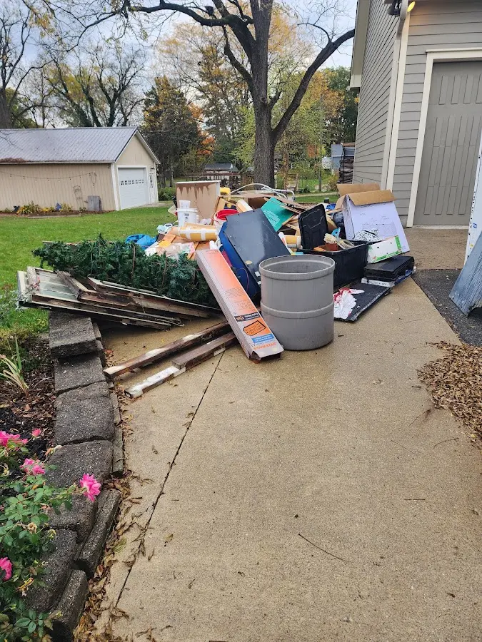 Dumpster being loaded with debris for Estate Cleanout Dumpster Rental in Farmington
